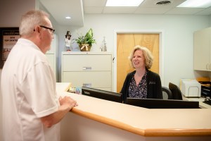 staff and patient at the front counter